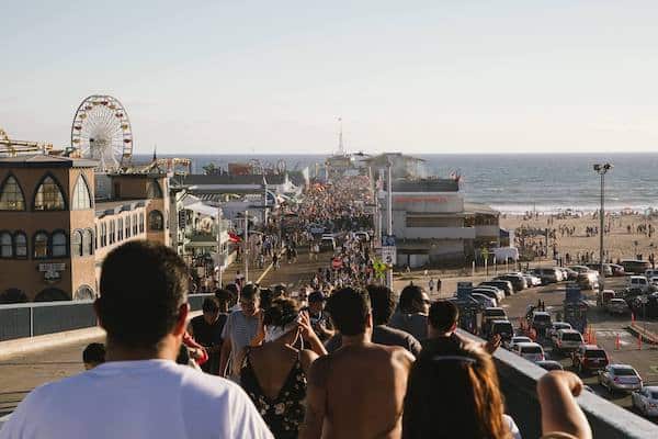 A crowd at a California beach symbolizes modern culture, the most important of the three society structures
