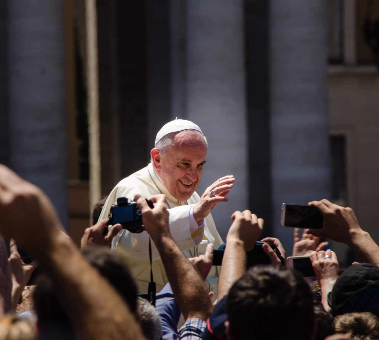 Pope Francis waves to crowd in St. Peter's square.